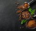 Coffee beans and coffee powder with tamper on dark background. Coffee concept. Coffee background. Flat Lay.